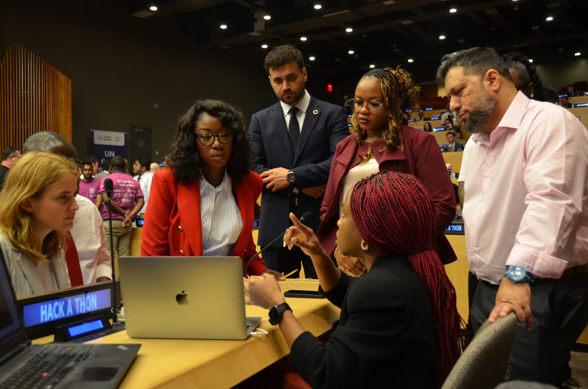 Umut Tutug with his team at a hackathon table in a UN conference room